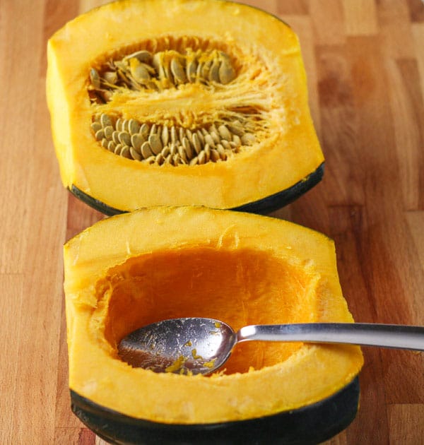 Scooping seeds out of Acorn Squash
