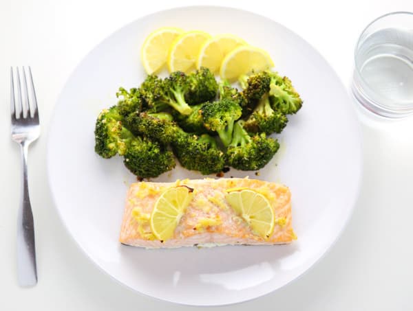 This Sheet Pan Lemon Garlic Salmon With Broccoli can be made in under 20 minutes! The Salmon is so tender, flaky, and delicious!