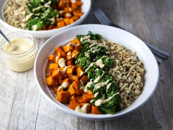 These Healing Turmeric Sweet Potato Kale Quinoa Bowls are loaded with goodness! Topped it with a Lemon, Tahini, Maple Syrup Dressing for the win!