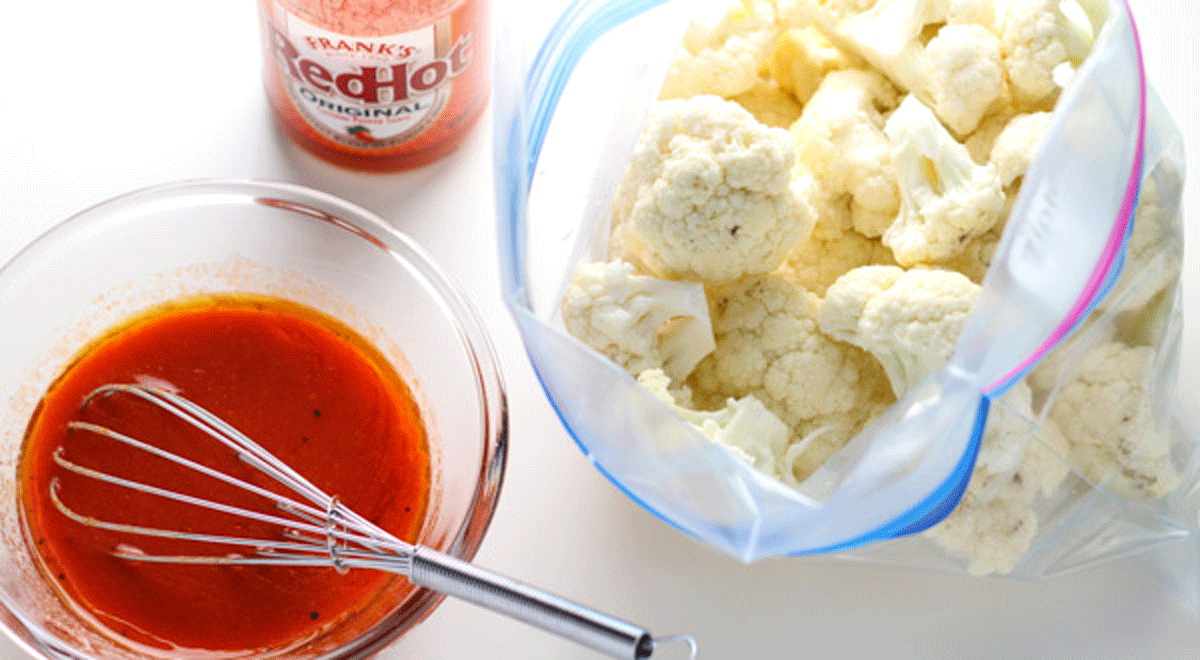 Cauliflower in a bag with a bowl of hot sauce