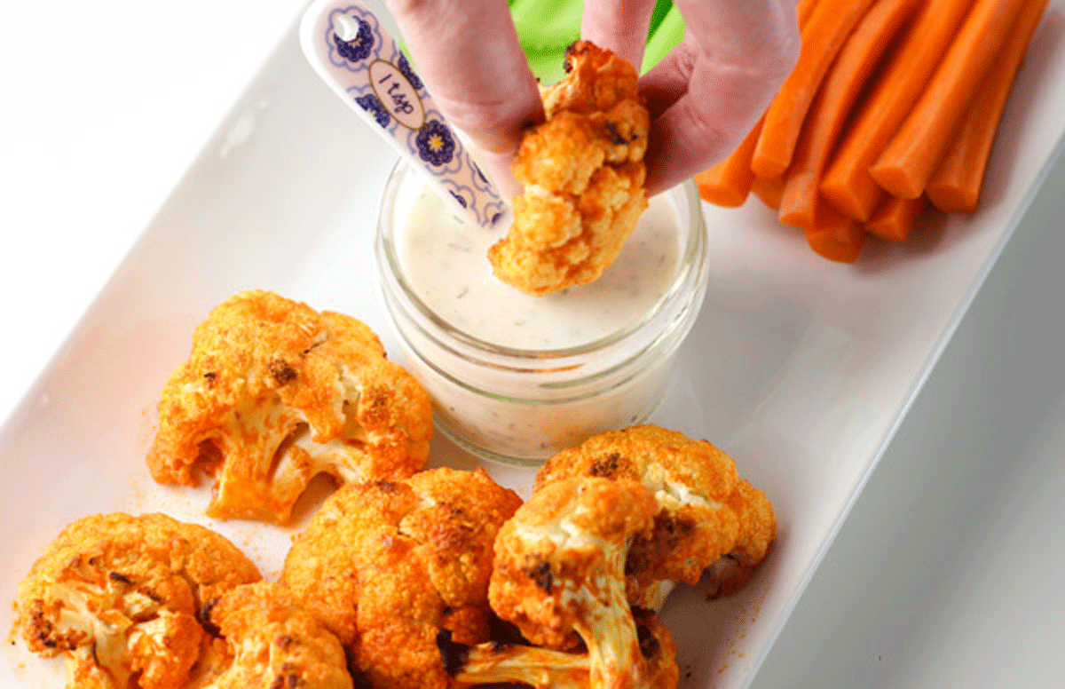 Dipping buffalo cauliflower in ranch