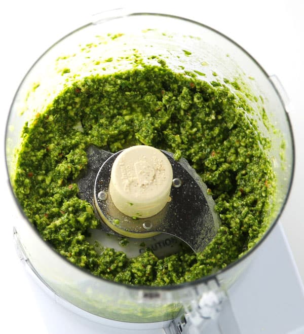 How To Make Basil Pesto - This is so easy to make and tastes so delicious! Dip your favorite bread in it, add it to pizza, or mix in with pasta!