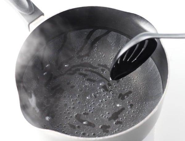 swirling water with a spoon 