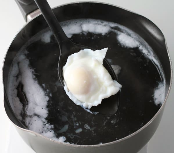 scooping out the egg from water