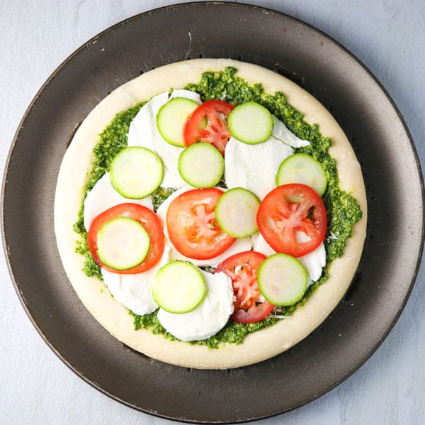 This Arugula Pesto Pizza with Tomato and Zucchini is so light, refreshing, and loaded with flavor! (Gluten Free)