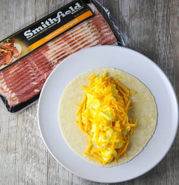 #ad Putting a new spin on Breakfast with this easy Bacon Wrapped Breakfast Burrito! Tastefulventure.com made in partnership with @SmithfieldBrand #BreakfastReimagined