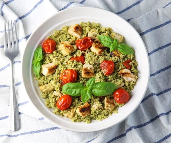 This Basil Pesto Quinoa with Grilled Chicken and Tomatoes is easy to make, healthy, and full of flavor! You can serve this warm or cold, so it's perfect for any time of year!