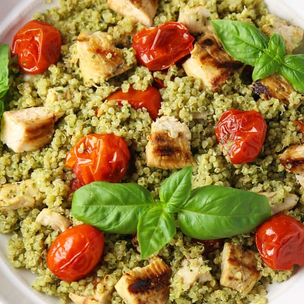 This Basil Pesto Quinoa with Grilled Chicken and Tomatoes is easy to make, healthy, and full of flavor! You can serve this warm or cold, so it's perfect for any time of year!