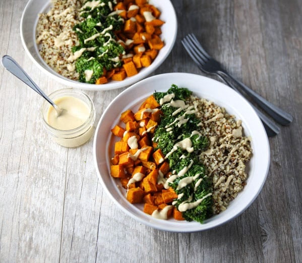 These Healing Turmeric Sweet Potato Kale Quinoa Bowls are loaded with goodness! Topped it with a Lemon, Tahini, Maple Syrup Dressing for the win!