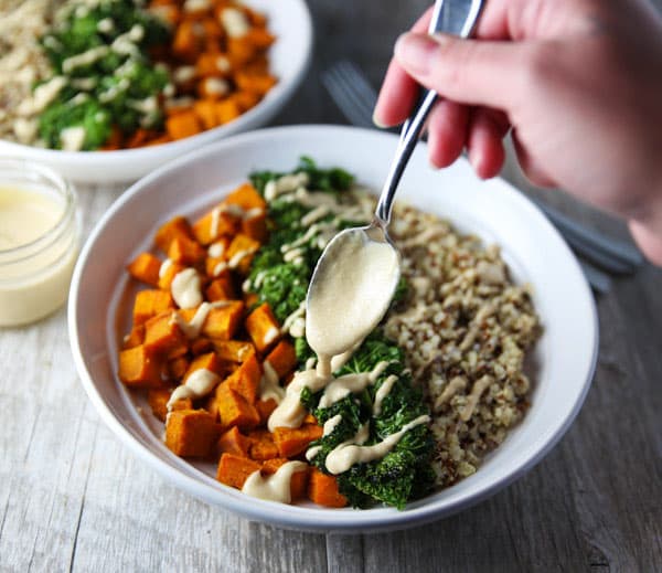 These Healing Turmeric Sweet Potato Kale Quinoa Bowls are loaded with goodness! Topped it with a Lemon, Tahini, Maple Syrup Dressing for the win!