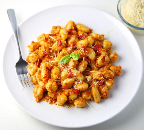 This Sun-Dried Tomato Pesto Gnocchi (Gluten Free) can be made in less than 10 minutes and is so delicious! Perfect for those busy week nights!
