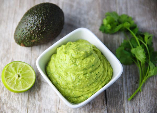 This Avocado Cilantro Sauce is made with simple fresh ingredients and is so addicting! This is great as a dip, or top it onto your favorite Mexican dish!