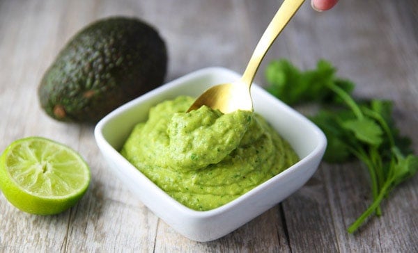 This Avocado Cilantro Sauce is made with simple fresh ingredients and is so addicting! This is great as a dip, or top it onto your favorite Mexican dish!