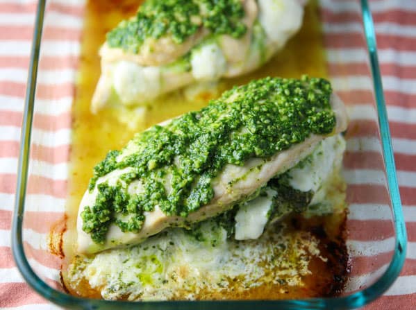 This Baked Chicken stuffed with Arugula Pesto and Mozzarella is super easy to make and loaded with flavor! This will be your new favorite easy weeknight meal!