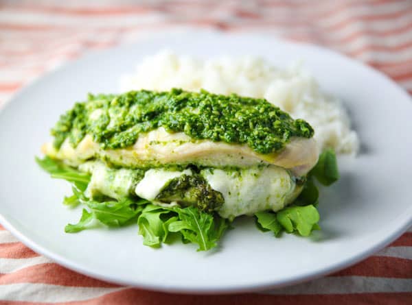 This Baked Chicken stuffed with Arugula Pesto and Mozzarella is super easy to make and loaded with flavor! This will be your new favorite easy weeknight meal!