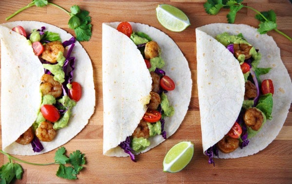 These Spicy Shrimp Tacos with Avocado Cilantro Sauce are totally addicting and loaded with flavor!