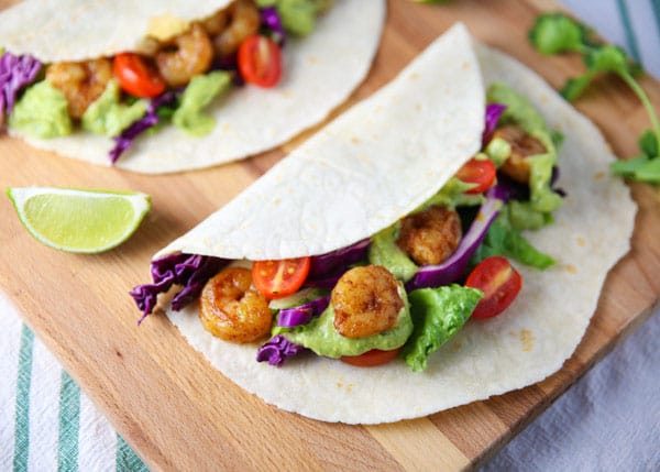 These Spicy Shrimp Tacos with Avocado Cilantro Sauce are totally addicting and loaded with flavor!