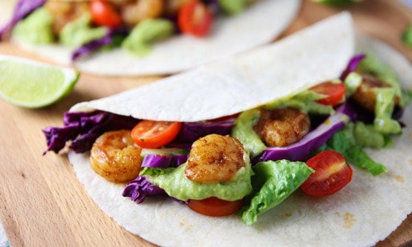 These Spicy Shrimp Tacos with Avocado Cilantro Sauce are totally addicting and loaded with flavor!