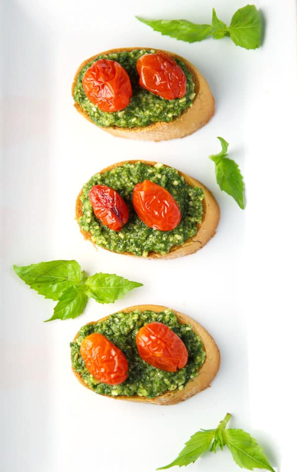 These Basil Pesto Crostini with Roasted Tomatoes are such an easy appetizer to make and a crowd favorite!