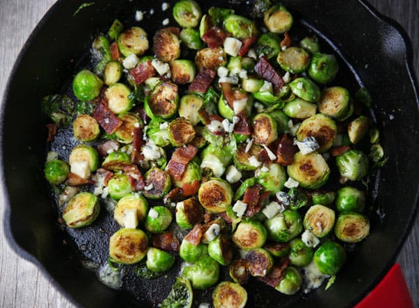 These Brussels Sprouts with Bacon and Gorgonzola could be the perfect side dish! The Brussels get cooked right in the Bacon grease, then with the mixed in Gorgonzola, this is absolutely drool worthy!
