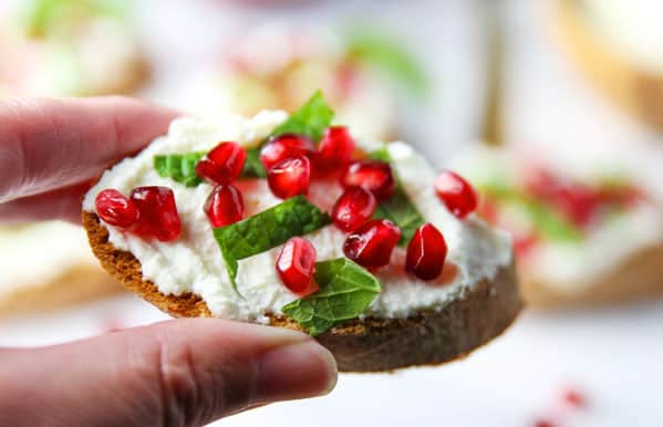 This Pomegranate Crostini with Ricotta and Mint will be your new favorite appetizer! It's super easy to make for any last minutes guests, and is sure to wow a crowd!