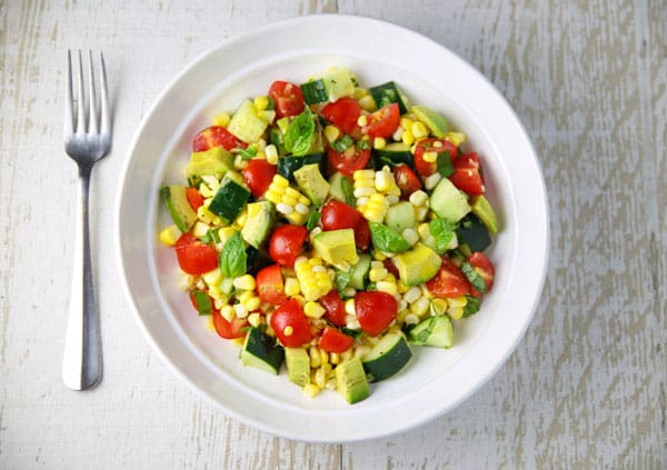 This Avocado Corn Tomato and Cucumber Salad is the perfect summer dish! Eat it as a meal or as a side!