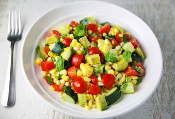 This Avocado Corn Tomato and Cucumber Salad is the perfect summer dish! Eat it as a meal or as a side!