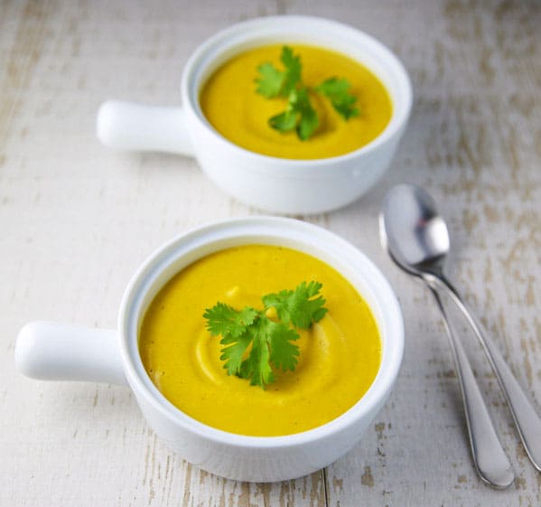 This Coconut Squash Soup with Turmeric and Ginger is so luscious, creamy, and flavorful! This soup is true comfort food! #coconut #squash #soup #vegetarian #glutenfree