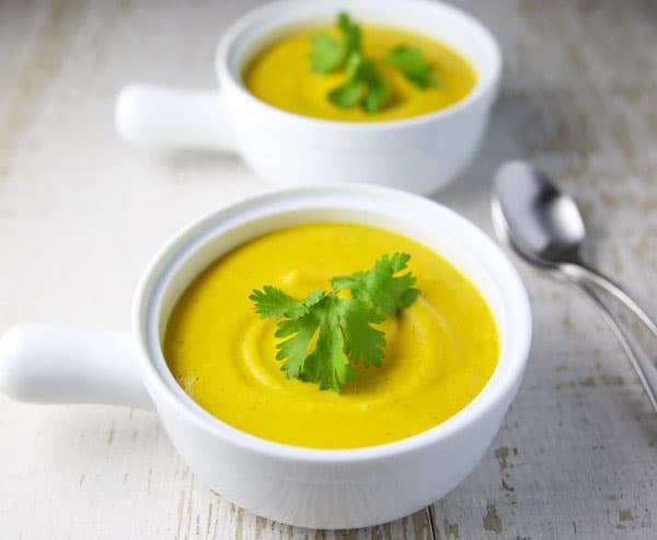 This Coconut Squash Soup with Turmeric and Ginger is so luscious, creamy, and flavorful! This soup is true comfort food! #coconut #squash #soup #vegetarian #glutenfree