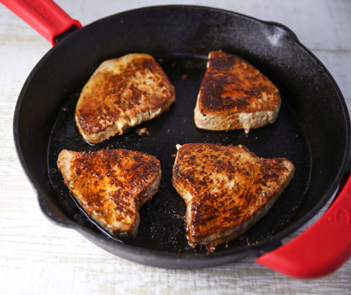 blackened tuna steaks in a skillet