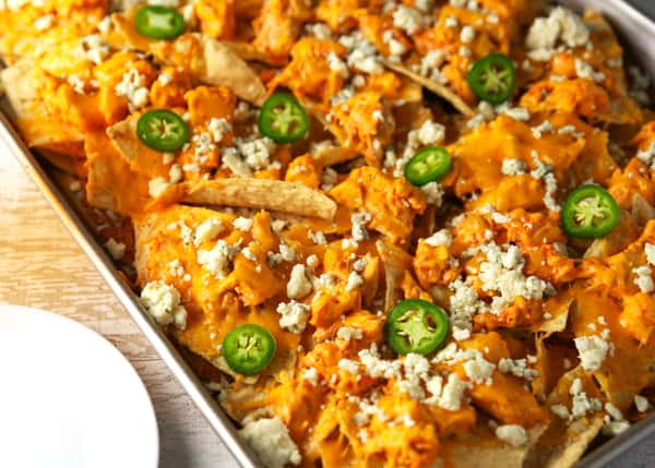 These Sheet Pan Buffalo Chicken Nachos are LOADED with flavor! They will definitely be a hit at your next party! #buffalochickennachos #buffalochicken #chicken #nachos #appetizer #appetizers #glutenfree #gameday