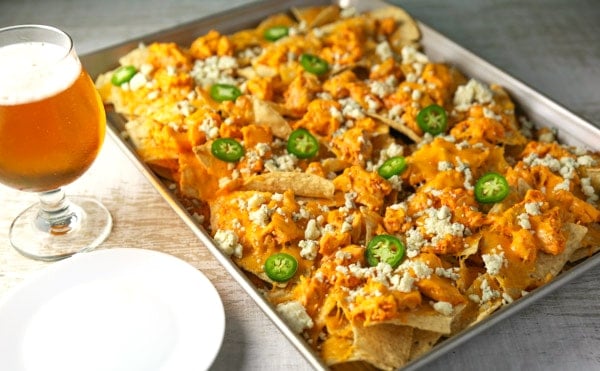 These Sheet Pan Buffalo Chicken Nachos are LOADED with flavor! They will definitely be a hit at your next party! #buffalochickennachos #buffalochicken #chicken #nachos #appetizer #appetizers #glutenfree #gameday