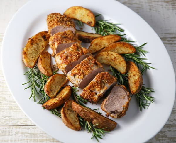 This Rosemary Parmesan Panko Crusted Pork Tenderloin is so tender, juicy and flavorful! Make this tonight and you can have a delicious dinner on the table in 30 minutes! #30minutemeals #dinner #pork #porktenderloin #glutenfree