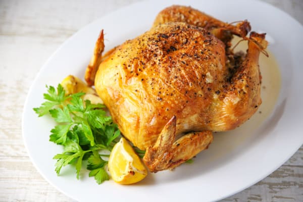 This Roasted Chicken with Lemon and Parsley could be the perfect Sunday dinner. It's so tender and juicy on the inside while the skin on the outside stays nice and crispy. #roastedchicken #chicken #wholechicken #glutenfree #dinner