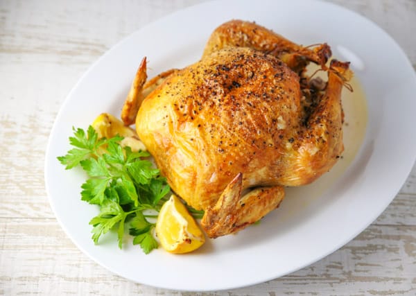 This Roasted Chicken with Lemon and Parsley could be the perfect Sunday dinner. It's so tender and juicy on the inside while the skin on the outside stays nice and crispy. #roastedchicken #chicken #wholechicken #glutenfree #dinner