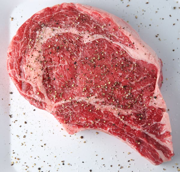 Raw Ribeye with salt and pepper