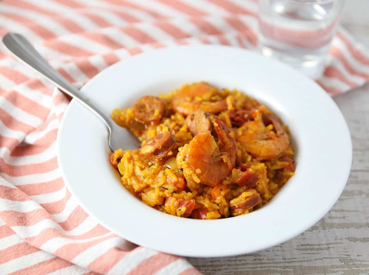 shrimp paella in a bowl with fork