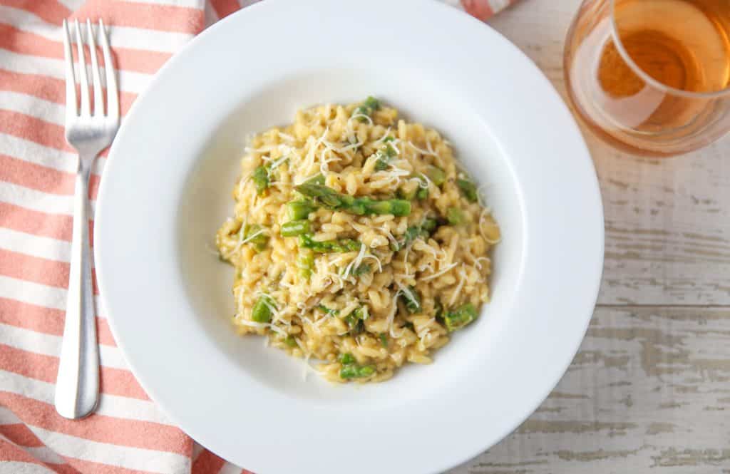 lemon asparagus risotto with a glass of wine and a fork