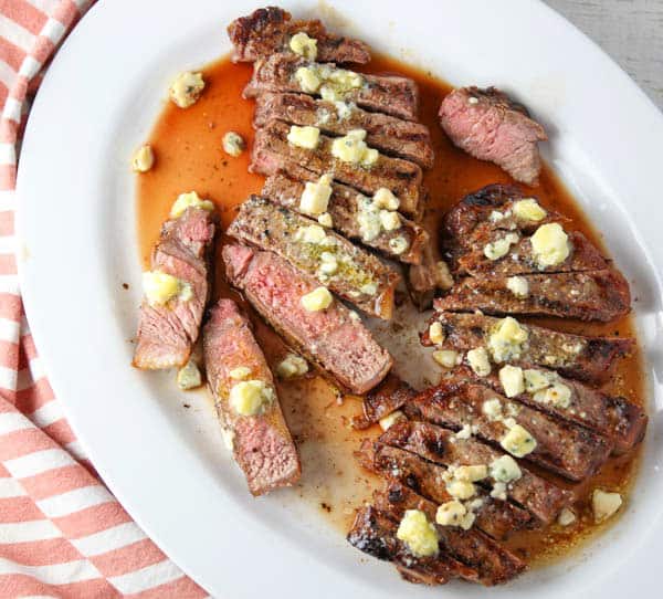 New York Strip Steaks cut up with Blue Cheese Butter