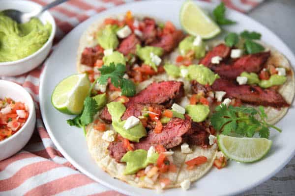 Blackened Flank Steak Tacos with Avocado Lime Sauce on a plate