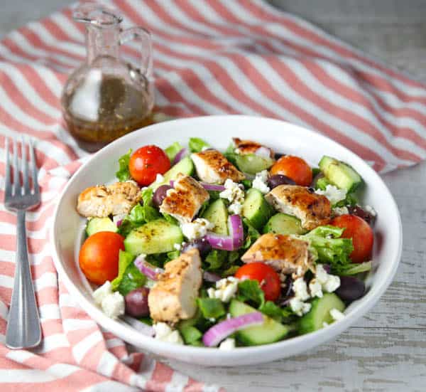 Greek Salad with Chicken and a bottle of dressing