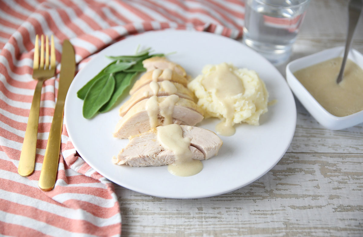 Slow Cooker Turkey Breast with White Wine Gravy on a plate with mashed potatoes