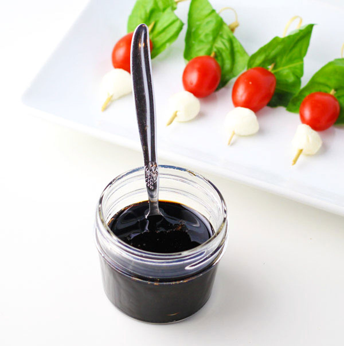 a spoon dipped in balsamic glaze