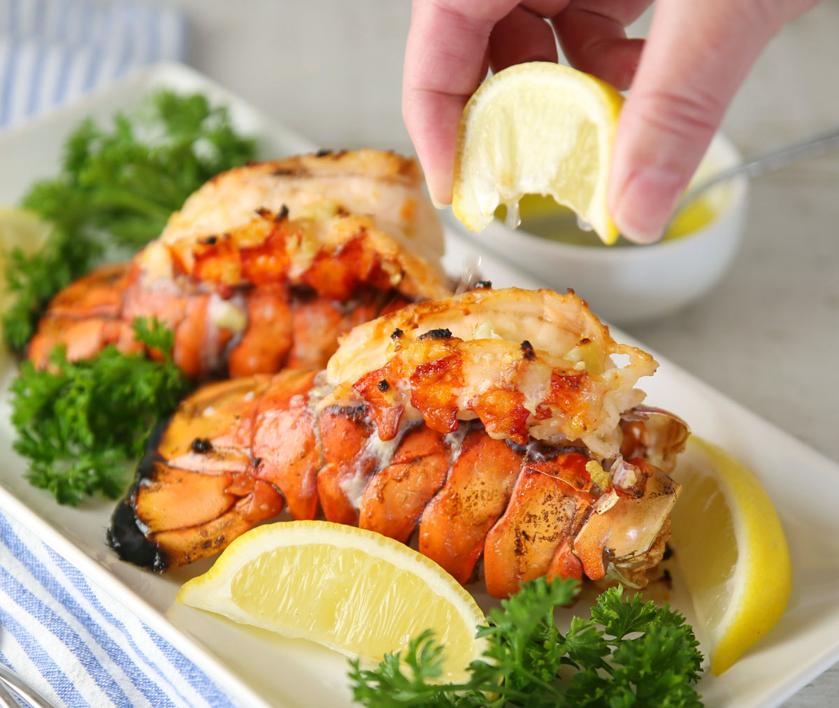 squirting lemon on lobster tail