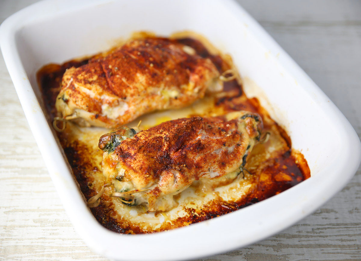 spinach and provolone stuffed chicken in a baking dish