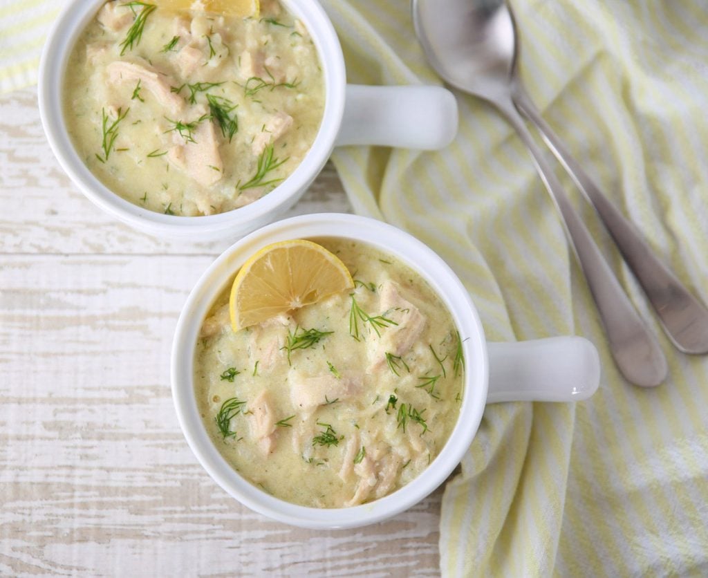 Greek Style Lemon Chicken and Rice Soup being ladled into bowls
