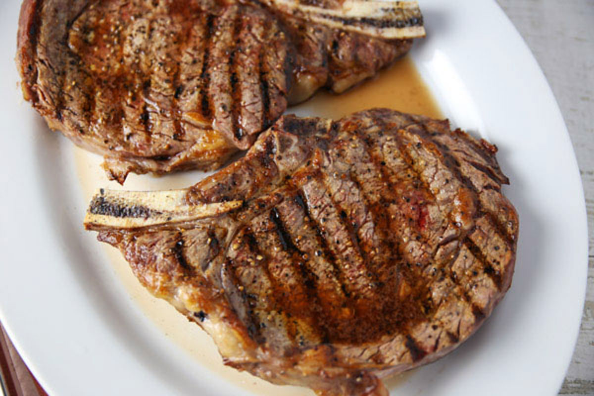 grilled ribeye steak on a platter