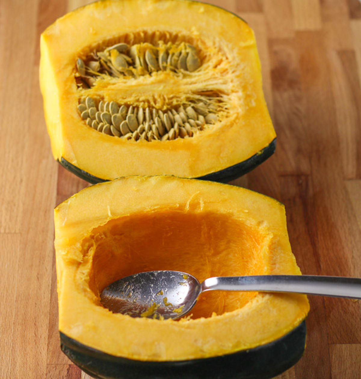 scooping out the seeds of an acorn squash