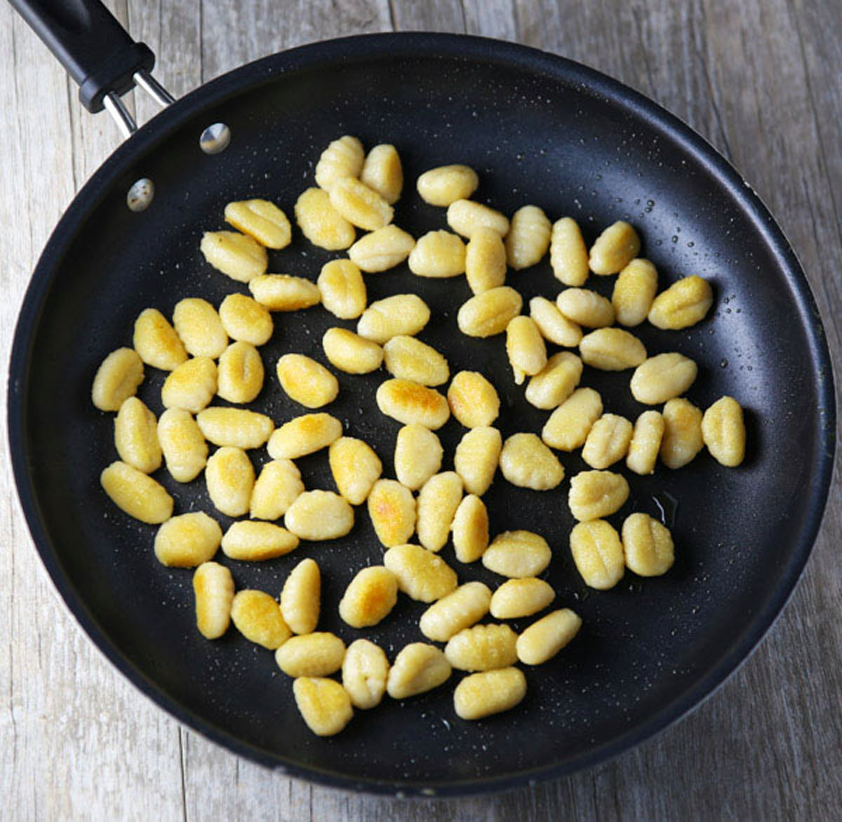 gnocchi frying in a pan