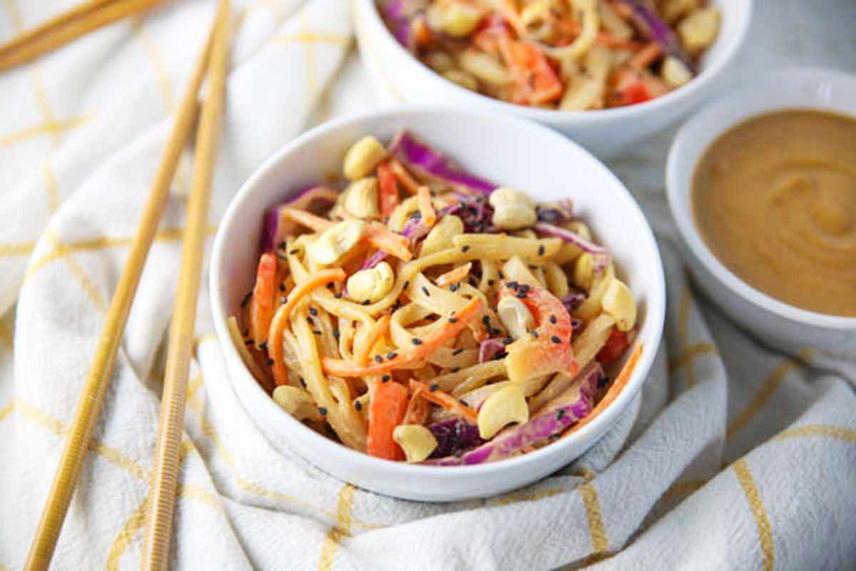 thai noodle salad with spicy peanut sauce in a bowl